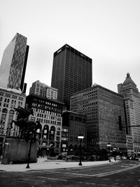 Modern buildings in city against clear sky