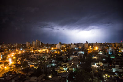 High angle view of illuminated buildings in city at night