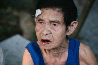 Woman with injured forehead outdoors