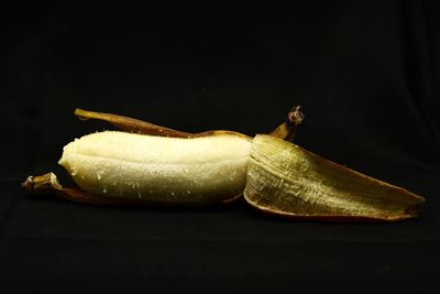 Close-up of lemon slice on table against black background