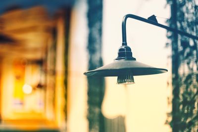 Close-up of lamp hanging against wall in building