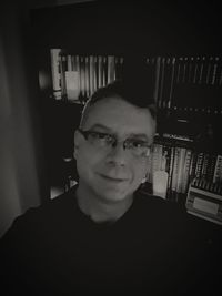 Portrait of young man standing against wall