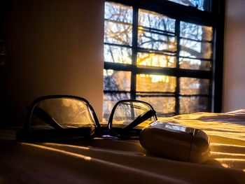 Close-up of eyeglasses on table against window