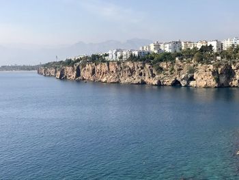 Panoramic view of sea and buildings against sky