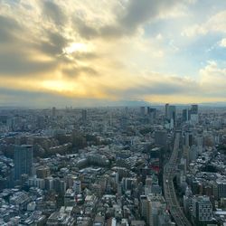 High angle view of modern buildings against sky during sunset