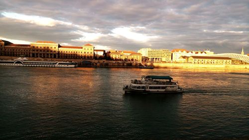 Boats in river with buildings in background