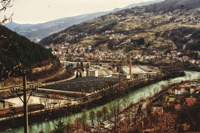 High angle view of river amidst buildings against sky