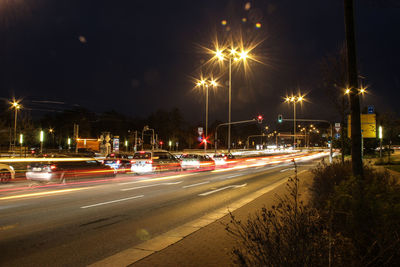 Light trails on road in city at night