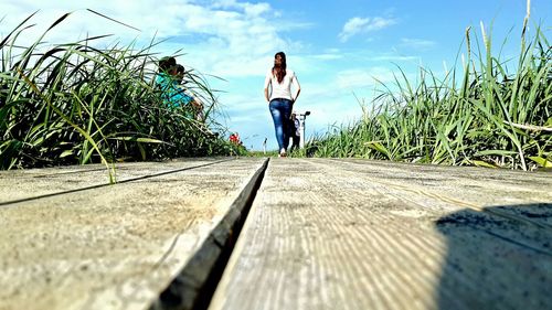 Rear view of woman standing on ground