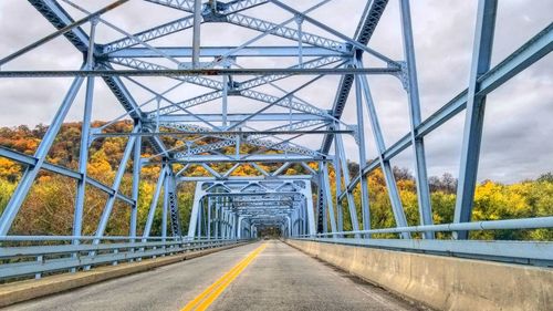 Road amidst bridge against sky