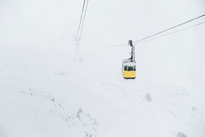 Overhead cable car on snow covered land