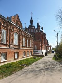 Street amidst buildings against clear sky