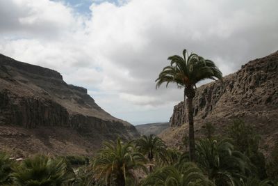 Scenic view of mountains against cloudy sky