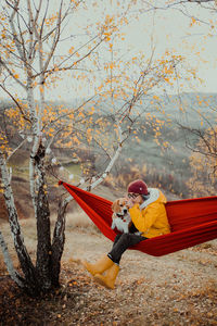 Rear view of woman sitting on hammock