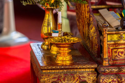 Close-up of illuminated lamp on table by building