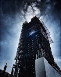 Low angle view of building against cloudy sky