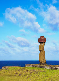 Lighthouse by sea against sky