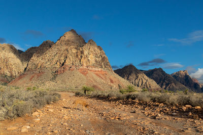 Scenic view of rocky mountains against blue sky