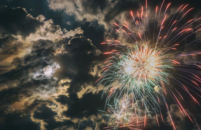 Low angle view of firework display at night