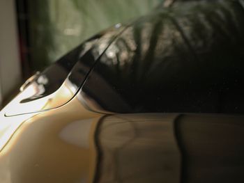 Close-up of wet glass bottle on table