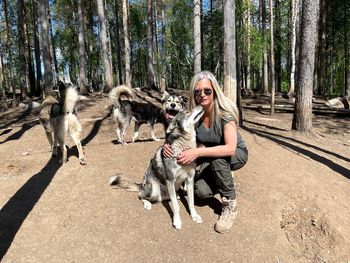 Young woman with dog in the forest