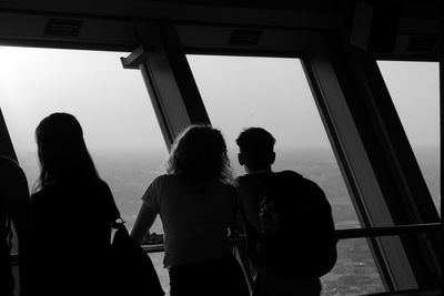 Rear view of people looking at sea against sky