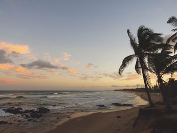 Scenic view of beach against sky during sunset