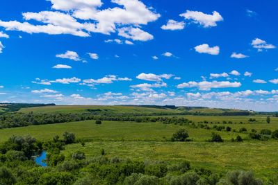 Scenic view of field against blue sky
