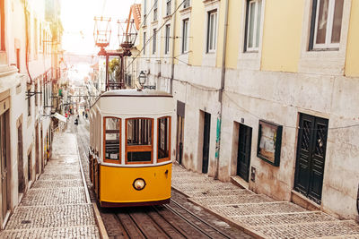 Traditional vintage yellow tram on the old street of lisbon, portugal