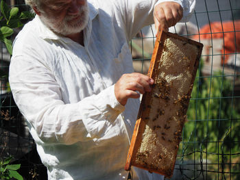 Midsection of man working at farm