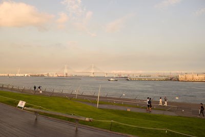 Bridge over river in city against sky