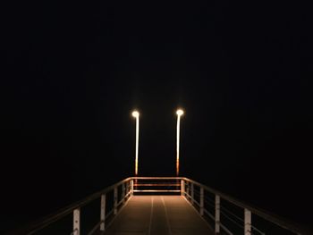 Illuminated staircase against clear sky at night