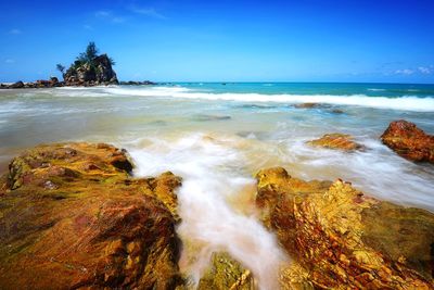 Scenic view of sea against blue sky