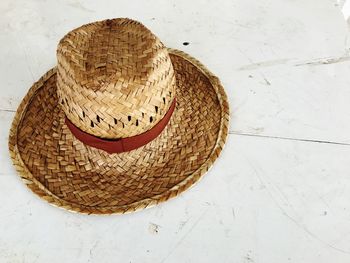 High angle view of hat on table against white wall