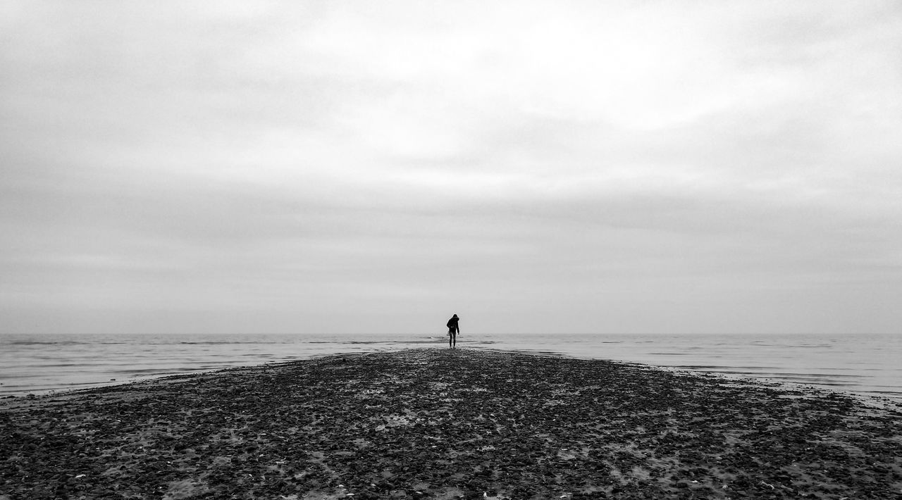 sea, sky, water, horizon, land, horizon over water, one person, cloud - sky, scenics - nature, standing, real people, tranquility, beach, beauty in nature, tranquil scene, nature, day, lifestyles, leisure activity, outdoors