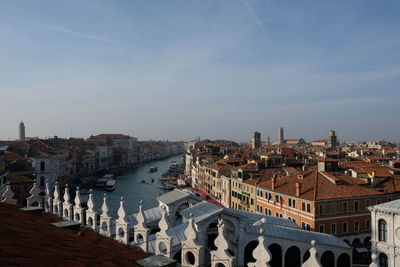 High angle view of buildings against cloudy sky