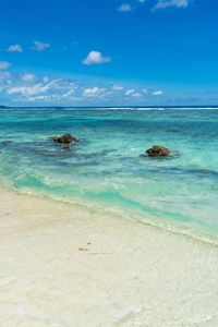 Scenic view of sea against blue sky