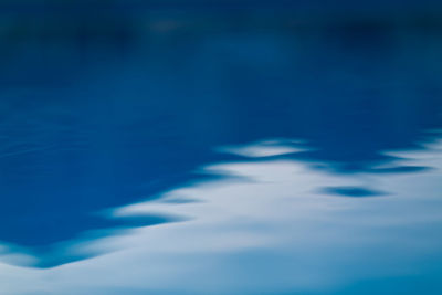 Defocused image of swimming pool against blue sky