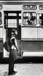 Full length of boy standing in train