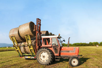 Tractor on field against sky