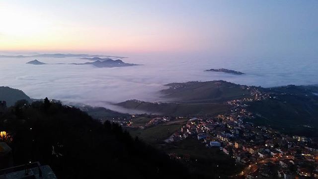 sea, mountain, high angle view, scenics, sunset, cityscape, beauty in nature, sky, building exterior, tranquil scene, city, aerial view, nature, landscape, water, tranquility, horizon over water, crowded, town, built structure