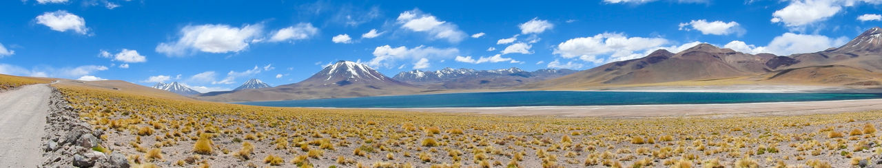 Panoramic view of landscape and mountains against blue sky
