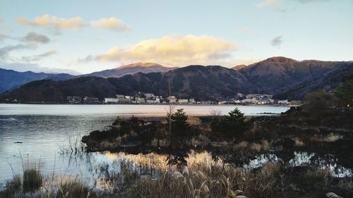 Scenic view of lake and mountains against sky