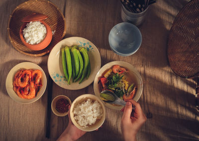 Cropped image of person having food at table