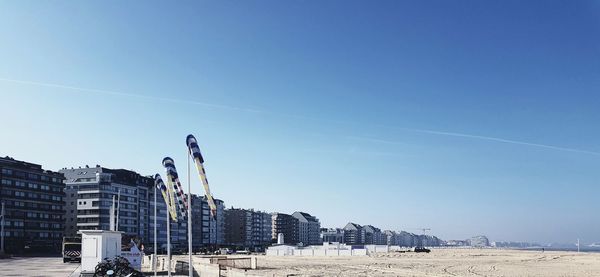 Low angle view of buildings against clear blue sky