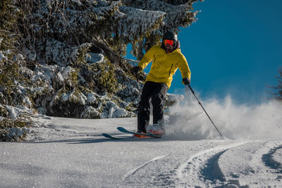 Man skiing on snow covered field