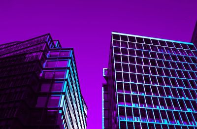 Low angle view of illuminated building against blue sky