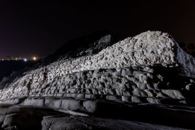 Close-up of rocks against sky at night