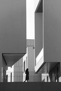 Woman walking in building corridor