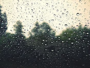 Full frame shot of wet glass window in rainy season
